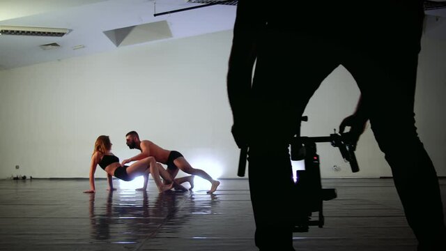 Modern dance recorded with motorized gimbal, videographer using dslr camera anti shake tool for stabilizer record video scene