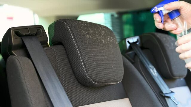 Cleaning solution is sprayed onto mold on a car seat head rest that has been left unused for several months