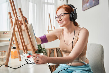 Woman painting in her living room
