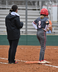 Girls in action playing in a softball game