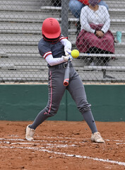 Obraz premium Girls in action playing in a softball game