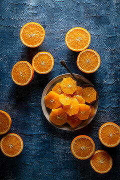 Flat Lay Of Plated Orange Slices On A Blue Background