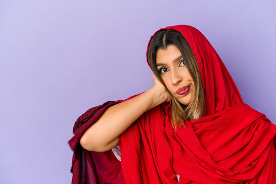 Young Indian Woman Wearing A Hijab Isolated Touching Back Of Head, Thinking And Making A Choice.