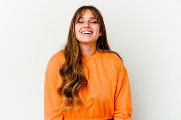Obraz premium Young caucasian cute woman isolated on white background laughs and closes eyes, feels relaxed and happy.