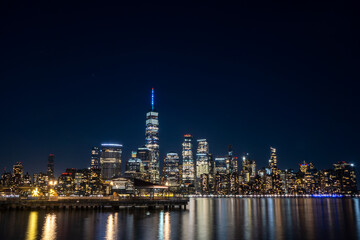 Jersey City, NJ - USA - Feb. 27, 2021: Wide angle landscape view of New York City's skyline at night. Seen from the Jersey City waterfront.