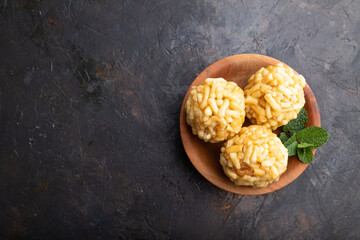 Traditional Tatar candy chak-chak made of dough and honey on a black concrete background. top view, copy space.