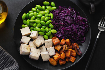 Appetizing vegan bowl with tofu on plate
