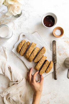 Tahini biscotti cookies in a flat lay with hand