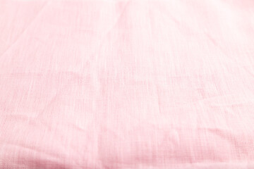 Fragment of smooth pink linen tissue. Side view, natural textile background.