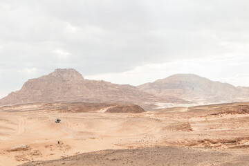 Fototapeta premium Desert, red mountains, rocks and cloudy sky. Egypt, color canyon.