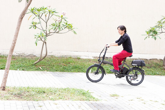 Man on electric bicycle going up hill in medellin