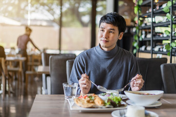 man eating with food in restaurant