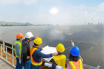 A man and a woman, an engineer and a supervisor, reading the blueprints at the construction site....