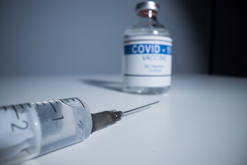 Syringe with Covid-19 vaccine - close up view macro shot