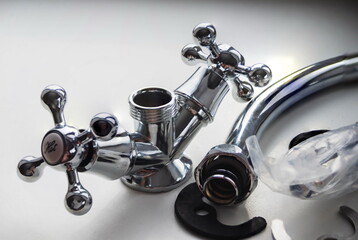 New chrome-plated water mixer, on a light background