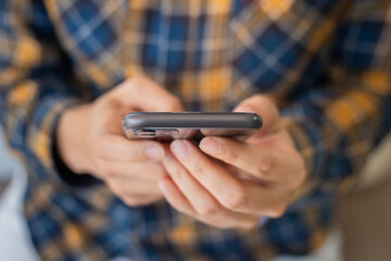 using cell phone hand holding mobile texting message contact us.chatting,search internet information in office.technology device communication connecting