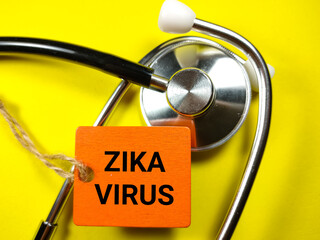 Medical concept.Word ZIKA VIRUS on wooden board with stethoscope on yellow background.