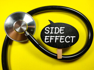 Medical concept.Word SIDE EFFECT with stethoscope on yellow background.