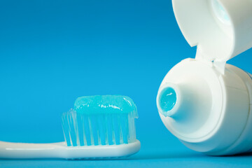 Toothbrush and toothpaste on blue background