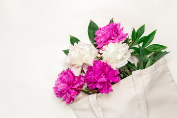 Cotton eco bag with peony flowers on white background Zero waste concept. Flat lay. Top view - Image