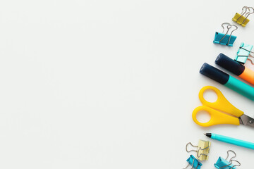 Clips, pencil, marker, scissors, white background. Work and education concept