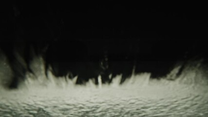 Water being sprayed on windshield and brush inside of automated car wash