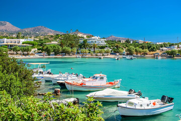 Fototapeta na wymiar Boats in Beautiful Beach Port in Lasithi Crete Greece