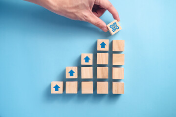 Businessman's hand arranging wooden blocks.