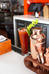 A view of a prepared Bloody Mary cocktail on a bar or restaurant counter.