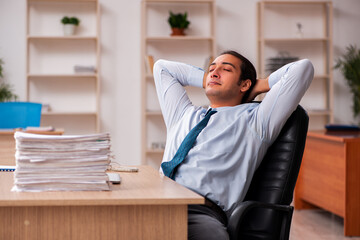 Young male employee unhappy with excessive work