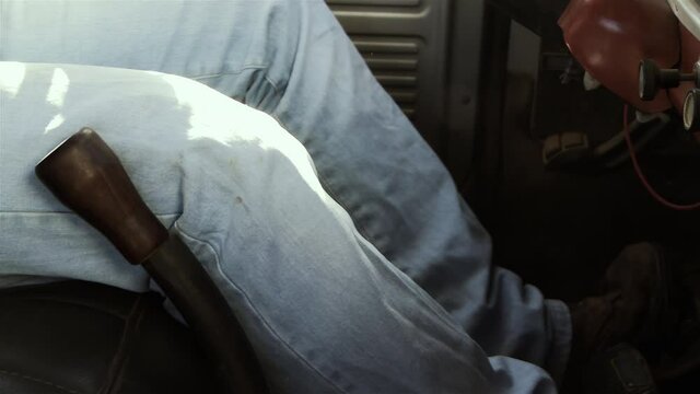 Man Shifting Gears in an Old Pickup Truck. Side Angle View. Close-Up. 4K Resolution.