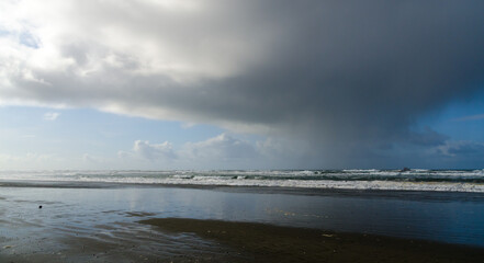 Clouds front over sand beach in Westport Lighthouse State Park, Westport