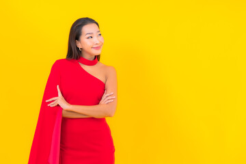 Portrait beautiful young asian woman smile with action on yellow background