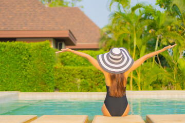 Portrait beautiful young asian woman relax smile enjoy leisure around swimming pool
