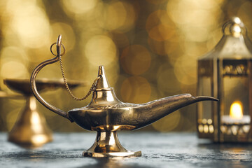 Aladdin lamp of wishes on table against blurred lights