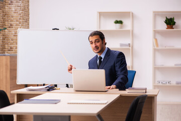 Young male employer in front of white board