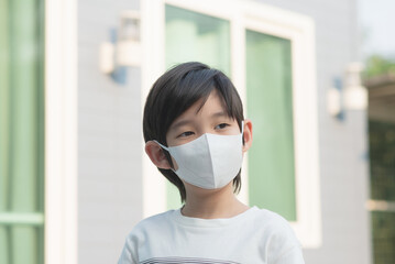 Cute Asian child wearing face mask