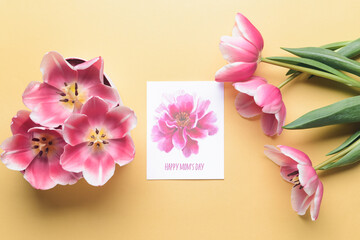 Beautiful flowers and greeting card for Mother's Day on color background