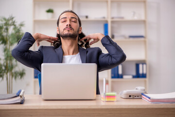 Young male employee working in the office