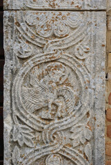 Moscufo - Abruzzo - Abbey of Santa Maria del Lago - Side detail of the portal with flat relief elements.