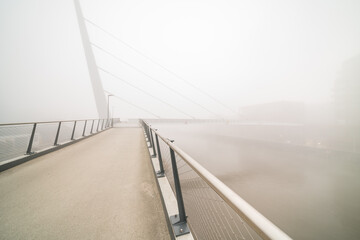 bicycle pedestrian bridge with fog