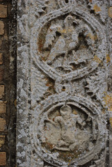 Moscufo - Abruzzo - Abbey of Santa Maria del Lago - Side detail of the portal with flat relief elements.