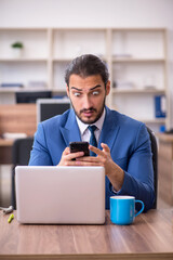 Young male employee working in the office