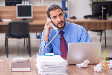 Young male employee in brainstorming concept