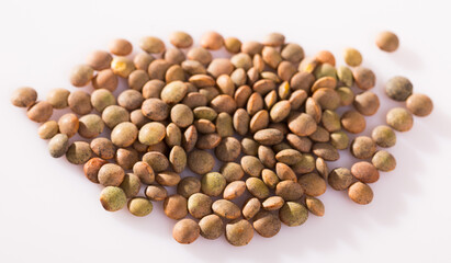 Natural background of lentils seeds on white surface, organic food