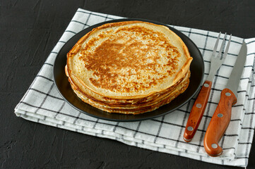 Crepes or Russian Blini on wooden backgroundin rustic style. Homemade thin crepes for breakfast or dessert.