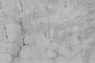 Old Concrete floor empty grey concrete wall background. Cement with cracks and natural destruction from time and weather conditions. Non-color, monochrome black and white photo.