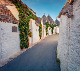 Сharm of the ancient cities of Europe. Bright morning view of empty strret with trullo (trulli) - ...