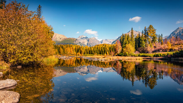Beautiful autumn scenery. Calm morning view of Strbske pleso lake. Spectacular outdoor scene of High Tatra National Park, Slovakia, Europe. Beauty of nature concept background.