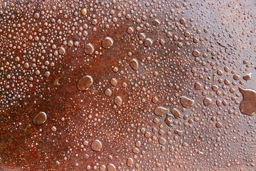 background of water drops on oily surface of iron sheet